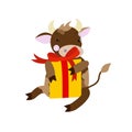 A cute bull sits with a gold box decorated with a red bow. Character with a Christmas present. Vector image on a white background. Royalty Free Stock Photo